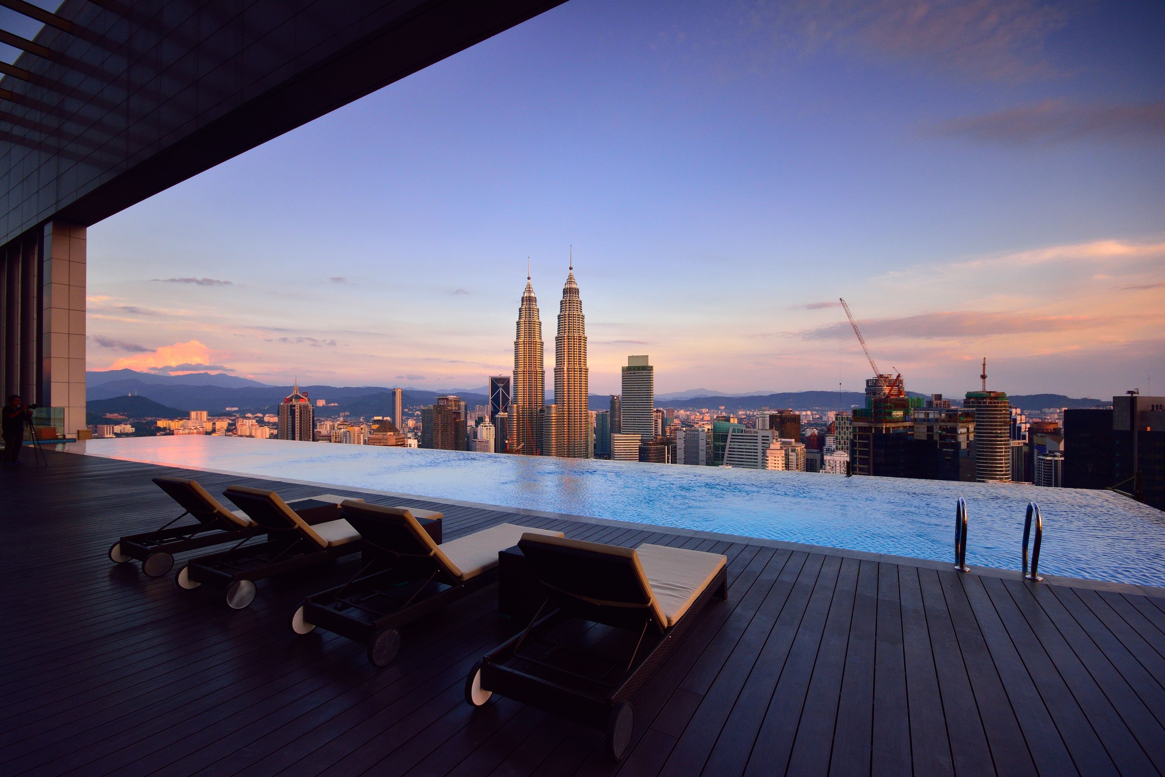 Rooftop infinity pool overlooking the KLCC skyline at sunset